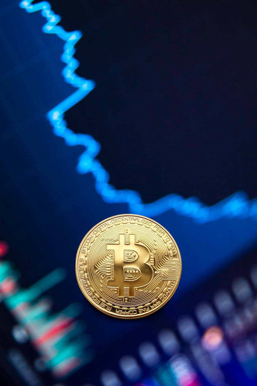 gold bitcoin coin on background of exchange chart